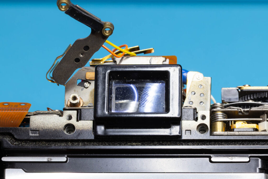 Canon A-1: Removal of mirror box - Two screws near the eyepiece removed