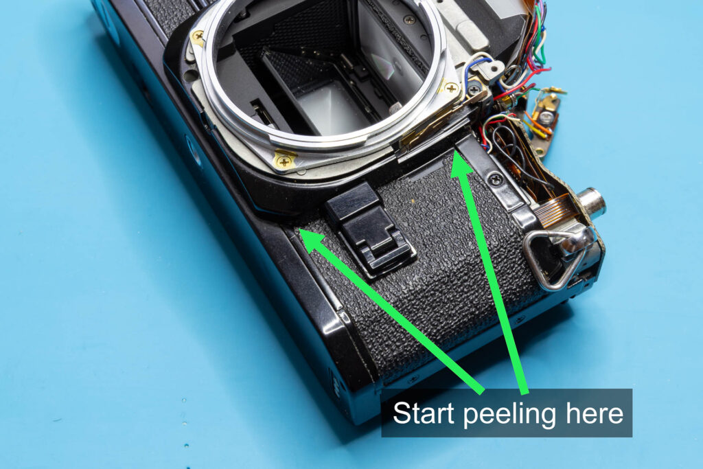 Canon A-1: Removal of mirror box - Edges of the right-side leatherette where you should start peeling it off