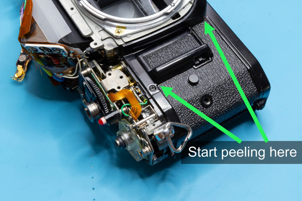 Canon A-1: Removal of mirror box - Edges of the left-side leatherette where you should start peeling it off