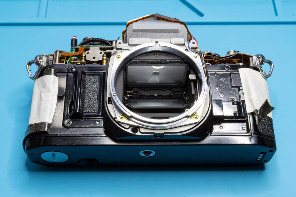 Canon A-1: Removal of mirror box - Left-side and right-side leatherette partially removed