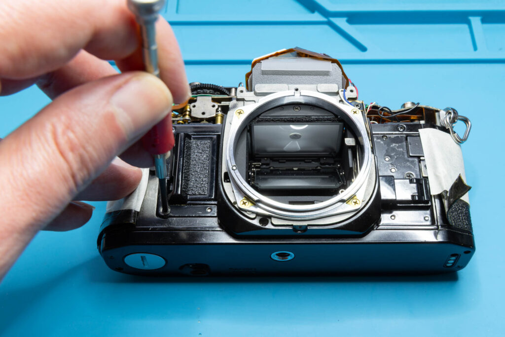 Canon A-1: Removal of mirror box - Remove the five screws holding the mirror box