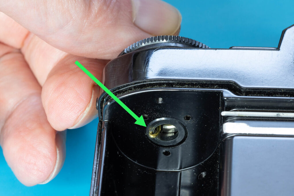 Canon A-1: How to Open the Back Cover - Catch the unlocking ring with the hook of the paper clip
