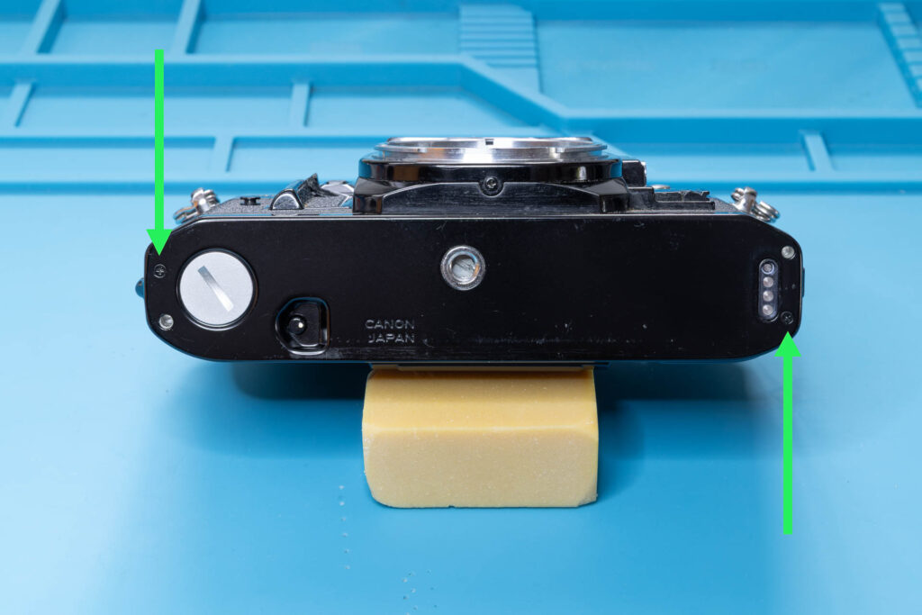 Canon A-1: Bottom cover before removal with positions of screws
