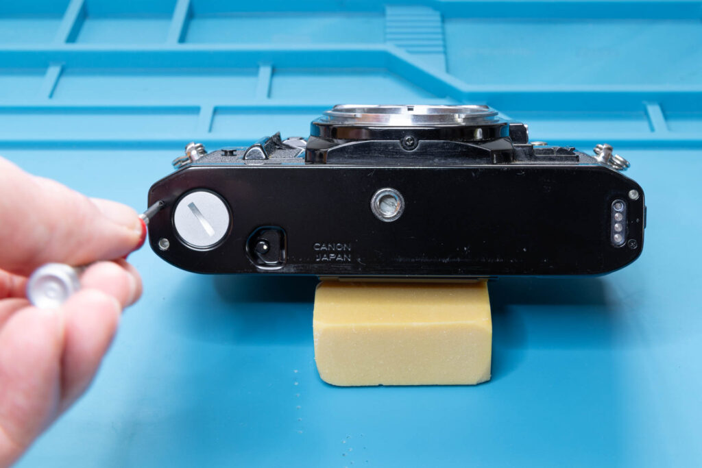Canon A-1: Remove screw #1 that holds the bottom cover