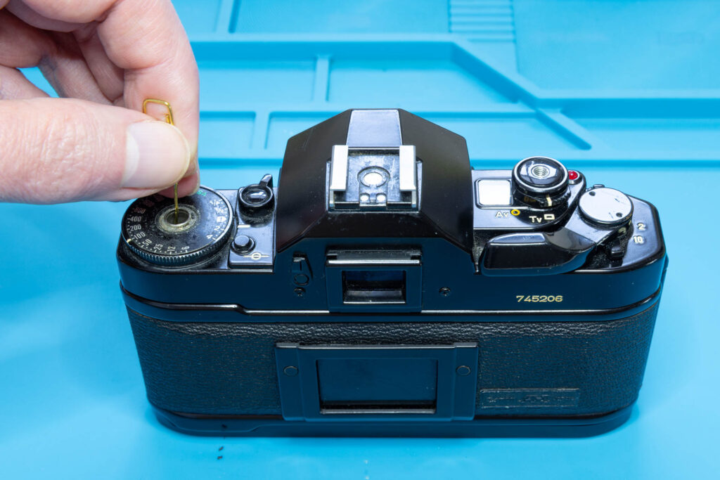 Canon A-1: How to Open the Back Cover - Insert the paper clip through the rewind shaft guide