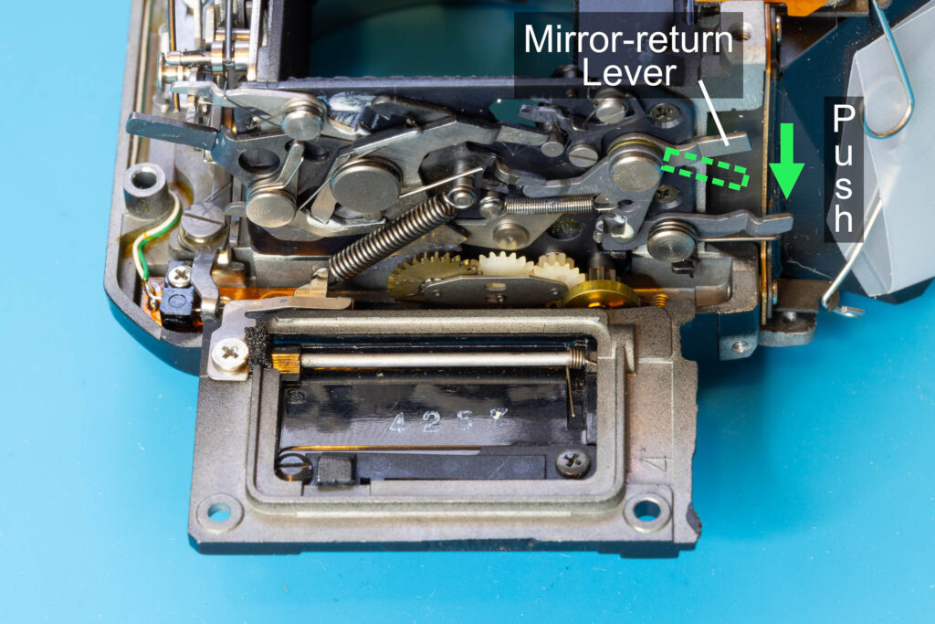 Canon A-1: Push down the mirror-return lever to lift down the mirror