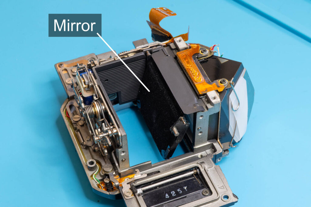 Canon A-1: Mirror box with left pivot of mirror inserted into bearing