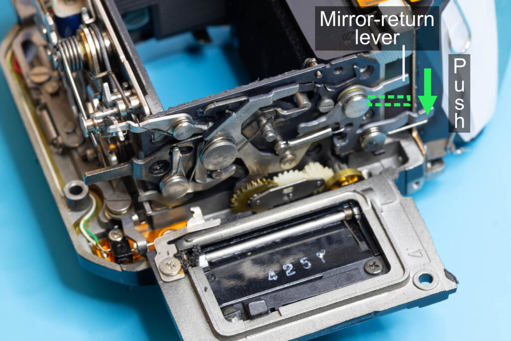 Canon A-1: Push the mirror-return lever to flip down the mirror