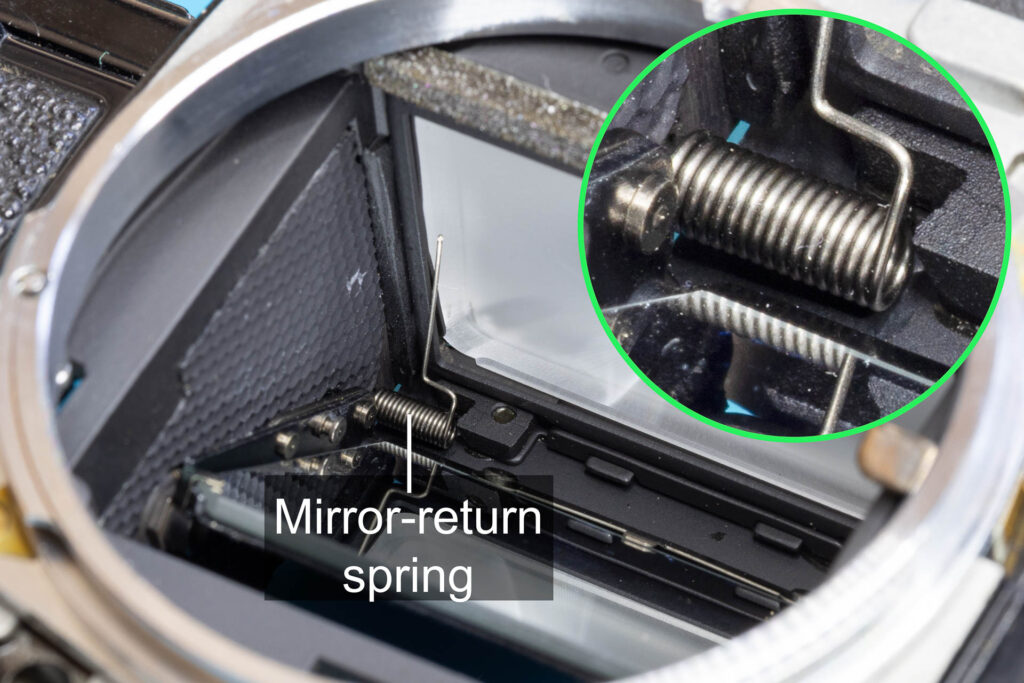 Canon A-1: Mirror-return spring placed in the upper left corner of the mirror box, not secured yet