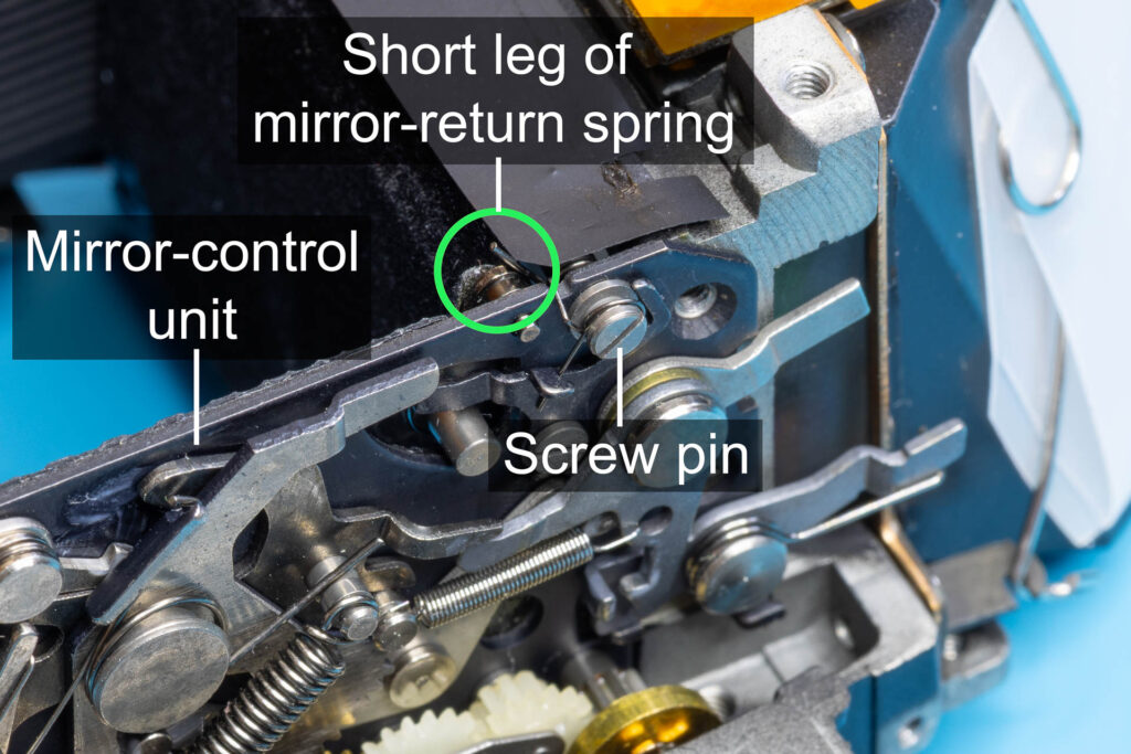 Canon A-1: Back of the mirror box with the short leg of the mirror return-spring sticking out