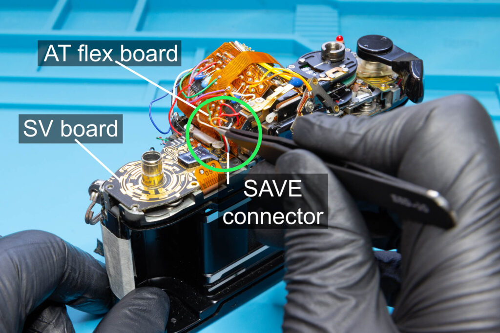 Canon A-1: Position wires 8, 10, 11, 12, and 
13 between AT flex board and SAVE connector, then push down the SV board