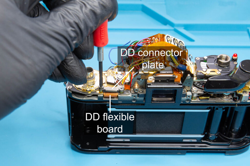 Canon A-1: Close the DD connector by installing the DD connector plate