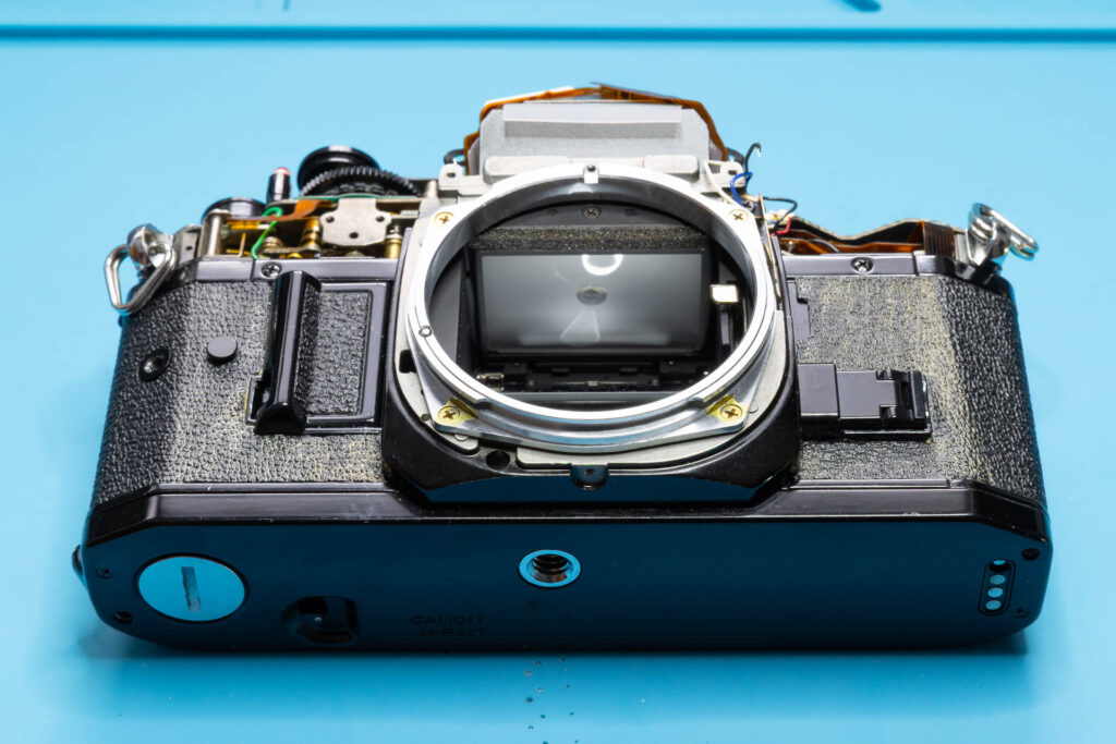 Canon A-1: Let the glue flash off for a couple of minutes, then press the leatherette onto the camera chassis