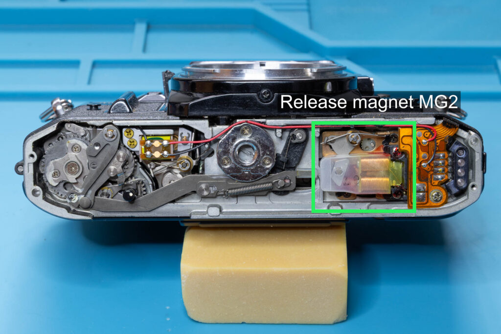 Canon A-1: Position of release magnet MG2 at the bottom of the camera