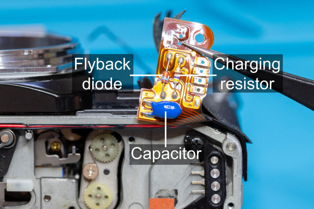 Canon A-1: Capacitor of release magnet MG2 on underside of flexible board